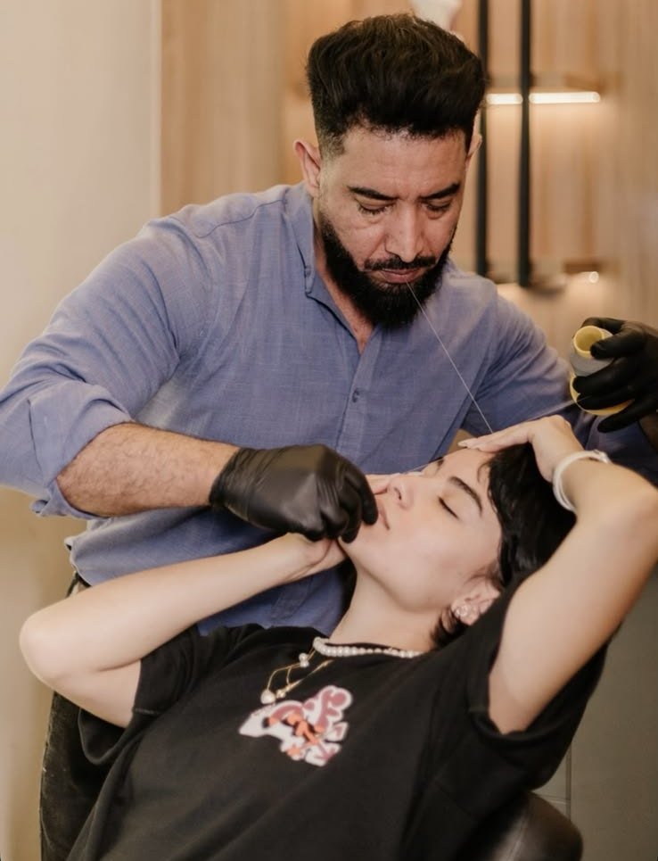 O Árabe fazendo epilação com linha em uma cliente